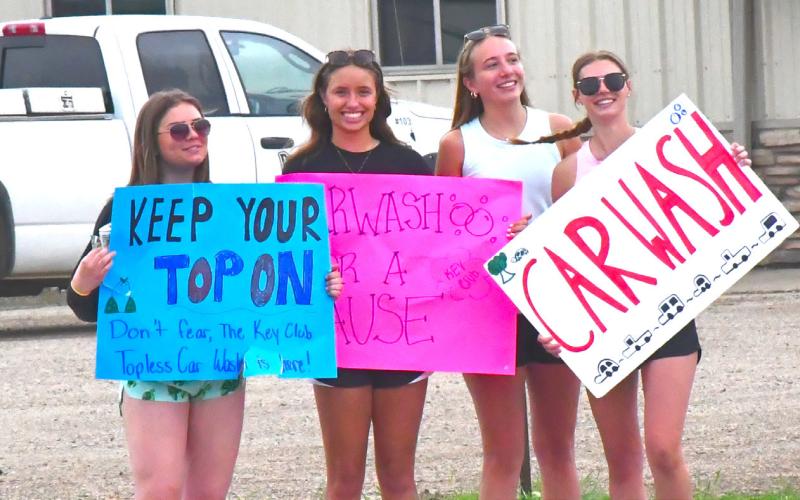 From left, Ava Bjerke, Kenslee Zubke, Kinsey Kuecker and Cartney Hanson are waving down cars and advertising for their car wash. Webster Area Key Club hosted a topless car wash June 1 for four hours. Reporter &amp;amp; Farmer | Connor Handrahan