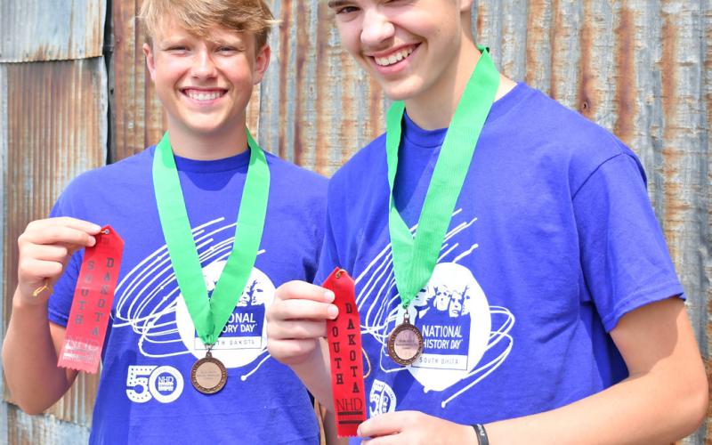 Jackson Baumgarn and Jase Voss smile as they hold ribbons they received from the National History Contest. The two traveled to Washington, DC to compete last month. Reporter &amp;amp; Farmer | Annie Witt