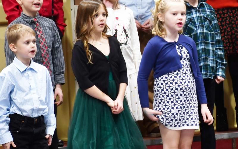 Located at the Webster Armory Dec. 9 k-6 students performed a variety of musical acts in the winter concert including a band and choirs. Here, second grade students from left in back, Archer Chevalier, Rhiley Zimmerman, Harlyn Deutsch along with middle row from left, Colten Hodge, Reagan Thompson, Lincoln Nimmer. From left in front row, Sawyer Zenk, Ava Schulz, Eva Garrett stand and sing holiday songs. Reporter &amp;amp; Farmer | Brenner Cariveau