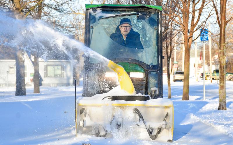 Brian Holland blows snow off a sidewalk outside Day County Courthouse March 18 in Webster. Reporter &amp;amp; Farmer | Leyton Beardslee