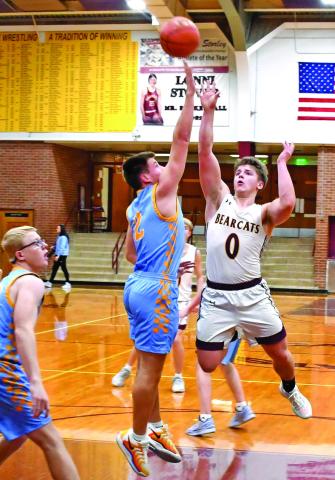 Webster Area Bearcats hosted the Hamlin Chargers Jan. 16 in a contest the Bearcats lost 22-71. Here, Tate Mammenga (0) attempts a floater over a pair of Hamlin defenders. Reporter &amp; Farmer | Robert Dulitz