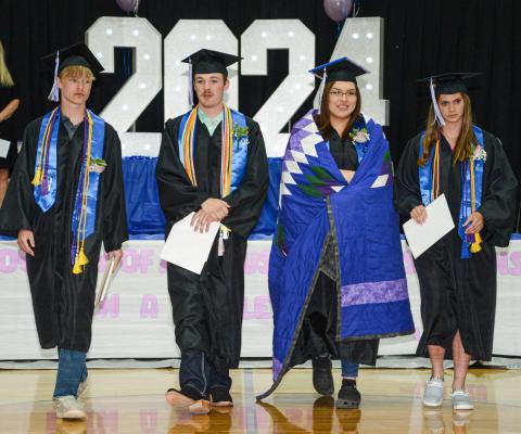 Members of the Class of 2024 from Waubay High School cross the school gym following the turning of their tassels at their graduation ceremony May 11. Pictured from left are Owen Niles, Caleb Weyh, Adryan Hopkins and Eva Benike. Reporter &amp; Farmer | Amanda Dulitz