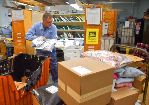 Randy Mount unloads several carts of parcells at the Webster Post Office Dec. 18. Mount has been working with the United States Postal Service as a city carrier in Webster for 28 years and plans to retire Dec. 26. Reporter &amp; Farmer | Connor Handrahan