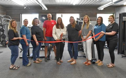 Reporter &amp; Farmer | Leyton Beardslee Webster Area Chamber of Commerce members hold up a ceremonial ribbon to be cut by Fit Zone owner Jen Keller May 14. From left: Chamber members; Bailey Meyer, Alisha LaCourse and Amy Fischer; Owners Aaron and Jen Keller; Chamber members Katy Marx, Lindsey Olson, Tammy Eidahl and Lindsey Koenig.
