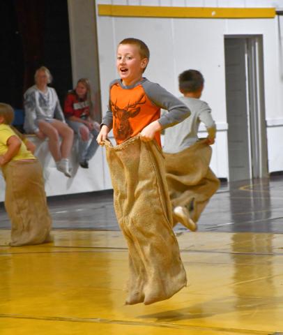 Landon Linde hops towards the potato-sack race finish line in the wrestling room during Webster Area School’s field day May 16. The field day was held indoors because of inclement weather. Reporter &amp; Farmer | Leyton Beardslee