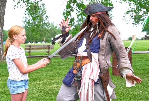From left, Eva Schuelke pointed a sword at Joshua Godfredson portraying Jack Sparrow June 7 during Fort Sisseton Historical Festival at Fort Sisseton State Park. Godfredson gave a performance educating attendees on the history of pirates. Reporter &amp; Farmer | Leyton Beardslee