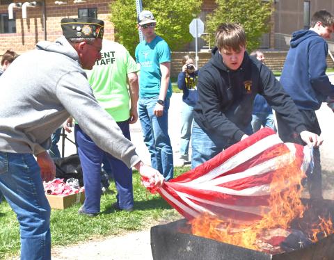 Webster Veterans of Foreign Wars (VFW) hosted a flag retirement at Webster Area School May 8. From left, Dan Kroll and Jacob Hoops participate in the ceremonial burning of the flags. Reporter &amp; Farmer | Connor Handrahan