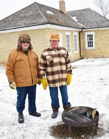 Chestnuts were being roasted for all attendees to try Dec. 14 at the Fort Sisseton Historical State Park’s Frontier Christmas. Here from left, Ernie Richards from Beaver and Kenny Anderson from Webster stand next to the fire pit as they wait for the chestnuts to roast. Reporter &amp; Farmer | Brenner Cariveau
