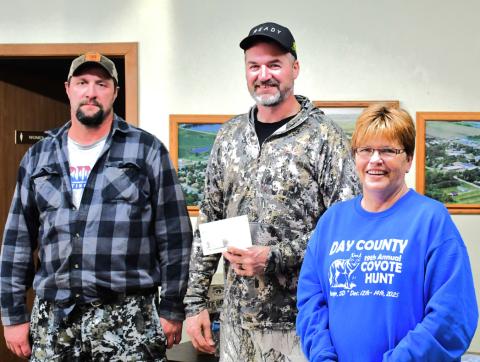 From left, Dale Peplinski and Joel Kaczynski are congratulated by Patti Mitchell for winning largest coyote. Peplinski and Kaczynski brought in a coyote that weighed 38.01 pounds for the Day County Coyote Hunt Dec. 14. Reporter &amp; Farmer | Connor Handrahan