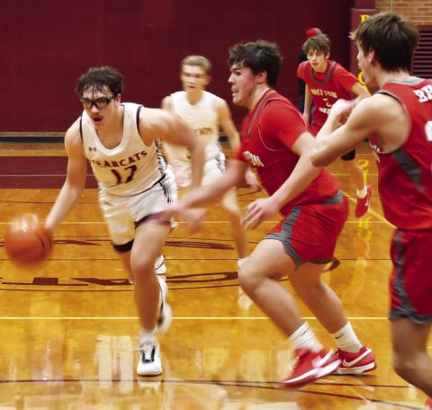 Webster Area Bearcats boys basketball took on the Britton-Hecla Braves Dec. 20 in a contest the Bearcats lost 46-56. Here, Webster Area forward Jeron McCreary (12) drives to the paint with Britton-Hecla defenders Graham Fosness (15) and Daniel Person (20) attempting to impede his route to the basket. Reporter &amp; Farmer | Brenner Cariveau