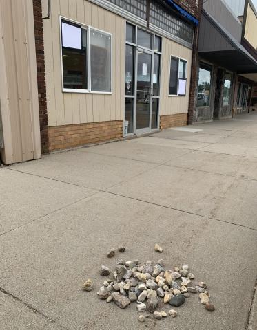 Rocks pictured Sept. 15 on Main St. in Webster were thrown from atop businesses towards adjacent businesses by two juveniles who were apprehended the night of Sept. 14. Two of the windows pictured at 508 Main St. were broken and patched. Reporter &amp; Farmer | Amanda Dulitz