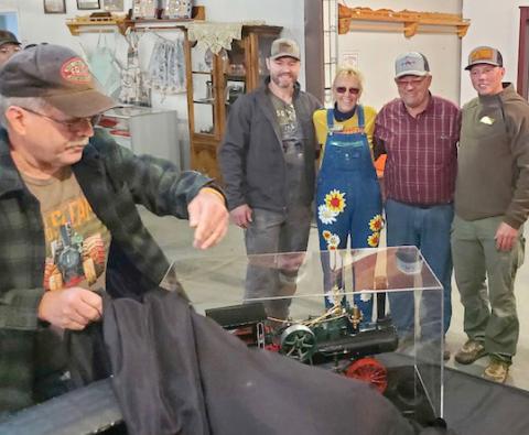 Sam Hoffman, left, from Elizabethtown, PA unveils a built-from-scratch 110 Case steam engine with working parts, for Scott Anderson’s 40th birthday. The engine took 1,000 hours to build. Hoffman regularly sets up his display at the James Valley Threshing show. Pictured, from right, are recipient Scott and his family Kevin, Donna and Kory Anderson. Reporter &amp; Farmer | Subscriber snapshot