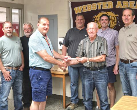 Webster Kiwanis donates $10,000 to the Webster Area School District. According to Kiwanis member Ken Roerig, this is the third of five donations Kiwansis pledged to make towards the school. Accepting the donation are Webster Area School board members from left, Aaron Gaikowski, Mark Hanson, Superintendent Jim Block, Joel Shoemaker, Roerig, Nick Fosheim and Tom Sannes. Reporter &amp; Farmer | Connor Handrahan