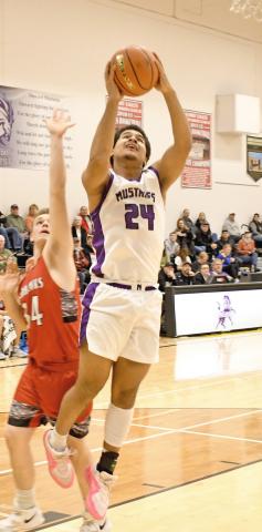 Waubay/Summit Mustangs Traveion Neilan goes up for a basket Feb. 11 in Summit when they played host to the Estelline/Hendricks Redhawks. Mustangs were left picking feathers out of their manes when the Redhawks flew away with the victory on the night, going 11-18, 20-25, 28-57 and 42-71. Reporter &amp; Farmer | Robert Dulitz