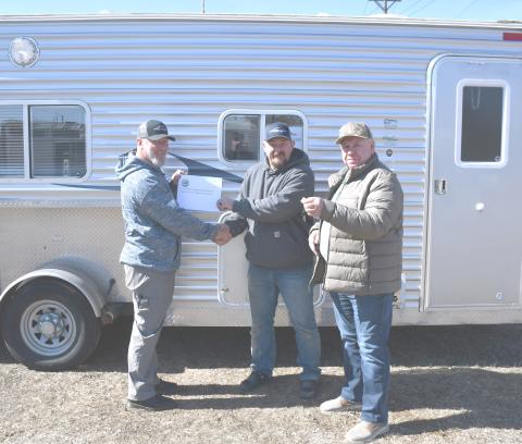 Izaak Walton League donated an ice shack to be used by veterans as a part of the Patriot House Project March 11. Here from left, Veterans Service Officer Jeff Nelson shakes hands with Josh Atherton and Larry Jirava holds the key to the ice shack. Reporter &amp; Farmer | Brenner Cariveau