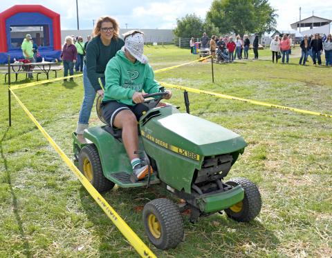 Participating in the lawn mower races at the first annual Harvest Bash Sept. 6 were April Hodges and her son Seth Hodges, 14. The duo, along with April Hodges’ other son Zach, traveled to Webster from Pierre to take in the festivities at the Day County Fairgrounds. See more from the day on 15. Reporter &amp; Farmer | Amanda Dulitz