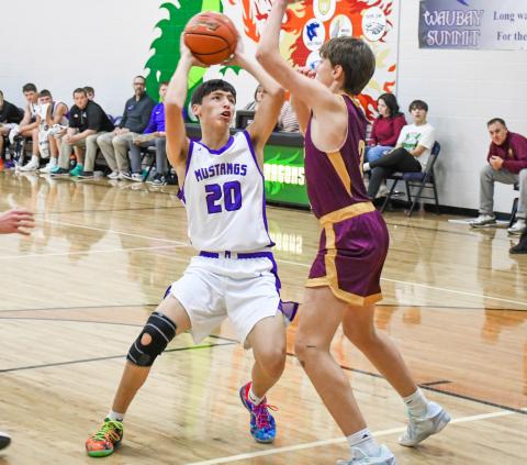 Newton Campbell (20) of Waubay/Summit drives towards the hoop during the Mustangs 67-38 victory over Langford Area Lions Feb. 2 in Waubay. Campbell finished the game with a team high 17 points in the win. Reporter &amp; Farmer | Rob Dulitz