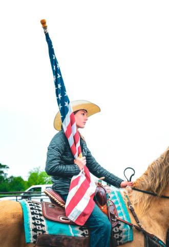 Bri White prepared for a performance of “The Star-Spangled Banner” ahead of the Waubay Roundup rodeo June 14. The first year for the annual rodeo went on despite rain earlier in the day which caused muddy arena conditions. Reporter &amp; Farmer | Leyton Beardslee