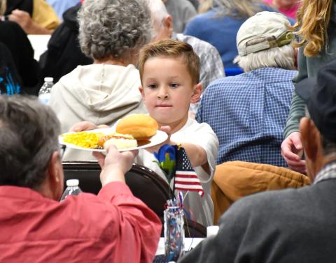 Jackson Meyer helps serve a meal during the veterans banquet at Webster Armory Nov. 8. Meyer is the son of Calvin and Bailey Meyer of Webster. Reporter &amp; Farmer | Leyton Beardslee