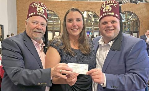 Lake Region Shrine Club members Josh Bartos, left, and Gary Fellbaum, right, present a donation check for $60,000 to Jennifer Sutch at the annual gala fundraising event for the Shriners Children’s Twin Cities hospital. Reporter &amp; Farmer | Subscriber snapshots