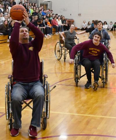As part of FFA week celebrations at Webster Area High School, the traditon of a teacher vs student wheelchair basketball game took place Feb. 21. Here from left, Nathan Bloom attempts to shoot a basketball while Christina Norton, Rylan Meuer and Jesse Williams trail behind. Reporter &amp; Farmer | Brenner Cariveau