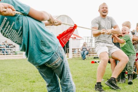 Tug of war players and Webster residents, from left, Isaac Nelson son of Jeff and Kari Nelson and five-year-old Hatcher Zubke, son of Brandon and Jess Zubke participate in the 4-H barnyard olympics organized by 4-H junior leaders at the Day County Fair Aug. 8. Nelson and Zubke’s team won the best of three rounds competition 2-1. Reporter &amp; Farmer | Leyton Beardslee