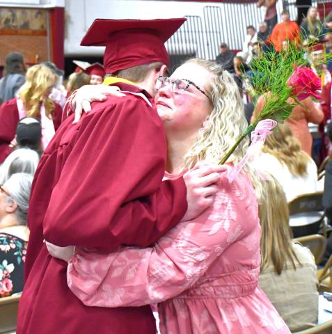 Webster Area High School held their graduation May 17 at Webster Armory. The stands and floor were packed with supporting friends and family. Angela Ayres hugs her graduate, Lukas Johnson, after he gives her a graduation flower. Reporter &amp; Farmer | Connor Handrahan