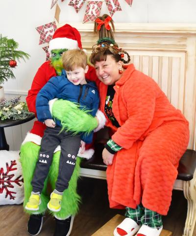 Four-year-old Griffin Lynde sits on the lap of the Grinch who made an appearance at the Brewhouse Dec. 21, along with Whoville resident Amanda Dohn. Lynde is from Webster and is the son of Matt and Megan Lynde. The event was part of a fundraising competition between the Grinch and Santa to see who could raise the most funds for six-year-old Jadyn Campbell who had open heart surgery Dec. 4.
