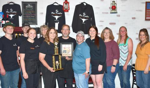 The New Frontier restaurant received their award from Webster Area Chamber of Commerce for winning the 2025 burger battle competition with their burger “The Homesteader.” In the restaurant June 10 are from left, New Frontier employees Delaney Atherton, Caleb Gaikowski, Brylie Reeves, Sharil Guthmiller, restaurant owners Kristi and Aaron Gaikowski and chamber members Alisha LaCourse, Kayla Fischer, Amy Fischer, Kelly Brandlee and Bailey Meyer. Reporter &amp; Farmer | Leyton Beardslee