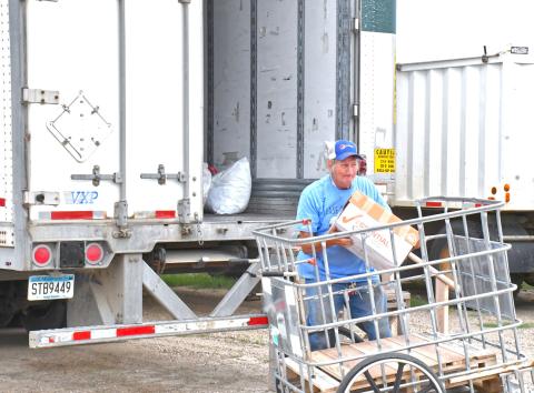 In last week’s issue, an article was published about a mysterious trailer that appeared in the farmer market’s parking lot and with help from a few community members, the trailer has been identified. Needs Anonymous has been using this trailer to collect their unsellable products and those donations will go to helping less fortunate people in Africa. Here, Howard Hvidsten can be seen loading items into the trailer. Reporter &amp; Farmer | Connor Handrahan