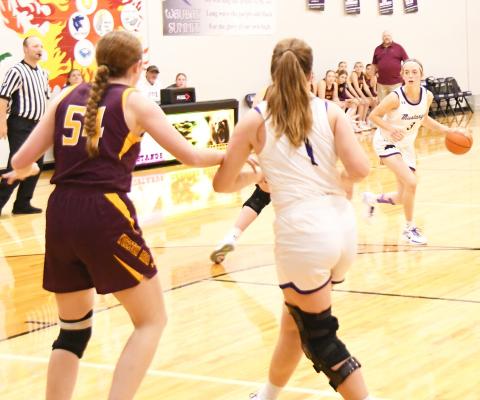 Waubay-Summit Mustangs hosted Webster Area Bearcats Dec. 10 in their season opener. The Mustangs prevailed in overtime 50-45. Here, Waubay-Summit’s Faith Larson (3) dribbles the ball inside the arch while her teammate Peyton Rumpza (1) attempts to clear out space from Webster Area Bearcat Karli Sannes (54). Reporter &amp; Farmer | Robert Dulitz