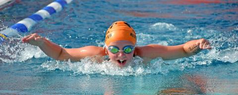 Webster Tigerfish Hadley Rithmiller throws her arms forward to propel herself through the water July 9 during the Webster 12 and Under Fun Meet. Reporter &amp; Farmer | Amanda Dulitz