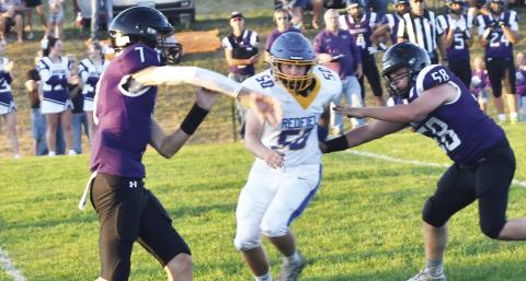 Sophomore Evan Aker (7) throws the ball against the Redfield Pheasants during Waubay-Summit’s homecoming contest against the Pheasants Sept. 20. Blocking for Aker is Caleb Miller (58). The Mustangs defeated the Pheasants 38-0. Reporter &amp; Farmer | Brenner Cariveau