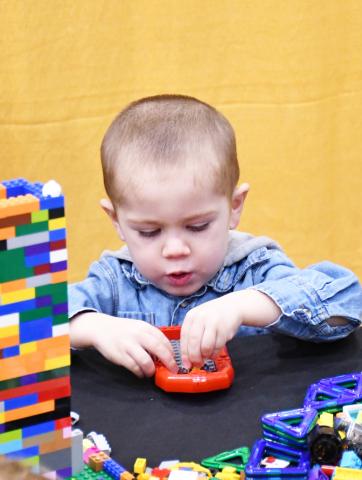 A plastic block building contest was an all day activity for both days of the Webster Area Farm and Home Show Jan. 24-25 at the Webster Armory. Here, three-year-old Maddix Schiley from Webster attempts to build a small strucutre with his blocks. Accompanying, Maddix was his grandfather Brock Otterness from Watertown. Reporter &amp; Farmer | Brenner Cariveau