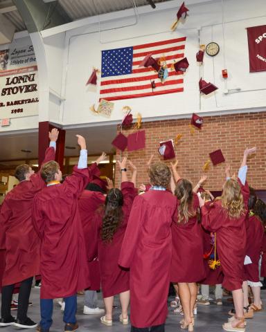 Webster Area High School graduates toss their graduation caps in the air following their graduation ceremony proceedings at the Webster Armory May 19. Thirty-two individuals crossed the stage to receive their diplomas that day. Reporter &amp; Farmer | Amanda Dulitz
