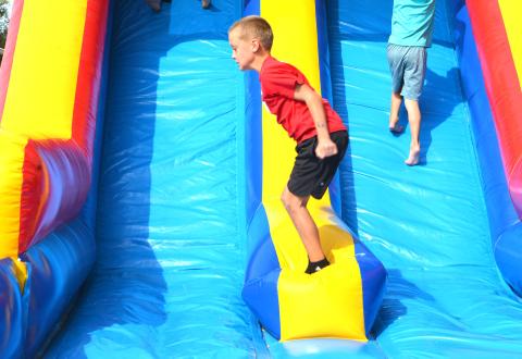 Many kids enjoyed the festivities held at Harvest Bash Sept 12. Lawson Vander Linden, age eight from Webster, hops from side to side on the inflatable side. Reporter &amp; Farmer | Connor Handrahan