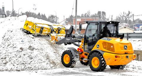 Avery Wyffels operates a piece of snow removal equipment Dec. 31 and piles snow in the back corner of a Webster business parking lot. He also helped move snow off roadways so drivers could motor safely following last week’s snowfall event. Reporter &amp; Farmer | Connor Handrahan