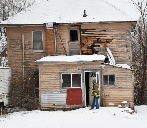 Firefighters revisited the 1106 Main St. house Dec. 10 accompanied by the Day County Sheriff and other men in hazmat suits. Fire Chief Robert Kwasniewski said no comment was available about the house due to the ongoing investigation. Here, Chris Gravley waits outside the back door during the visit of the home. The Main St. house was originally a part of a fire Sept. 9 with the cause of the fire never officially released. Reporter &amp; Farmer | Brenner Cariveau