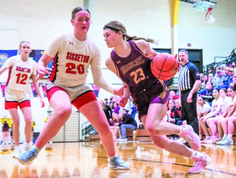 Cartney Hanson (23) of Webster Area drives past Piper Langager (20) of Sisseton Redmen during their playoff matchup Feb. 24 in Sisseton. Bearcats fell in the game with a final score of 35-70 ending their season. Reporter &amp; Farmer | Leyton Beardslee