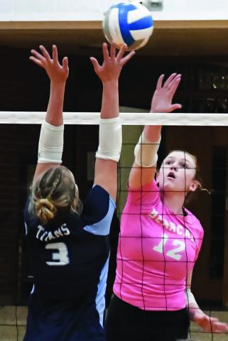 Karli Sannes (12) of Webster Area hits the ball over Kalyce Achen (3) of Leola/Frederick Area during the Bearcats 3-0 match win over the Titans Oct. 6 in Webster. Set scores for the match were 25-11, 25-21 and 25-16. Reporter &amp; Farmer | Amanda Dulitz