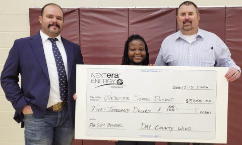 Webster Area School received a donation from Day County Wind totaling $5,000 to fund new basketball hoops and backboards for the Webster Elementary gym Dec. 12. Here from left, site manager for Day County Wind Trevor Campbell stands next to physical education and health teacher Ilienne Jaycox and k-8 principal Craig Case as they hold the check. Reporter &amp; Farmer | Subscriber Snapshot