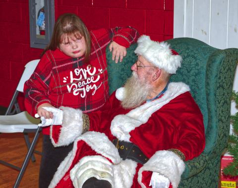 Roslyn Booster Club invited Santa to celebrate Christmas with them for their appreciation day and holiday celebration Dec. 5. Santa brought his Christmas spirit and asked KrisLynn Town what gifts he could bring her on Christmas Eve. Reporter &amp; Farmer | Connor Handrahan
