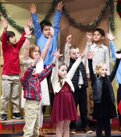 Webster Area Elementary grades k-6 participated in te winter concert at the Webster Armory Dec. 9. Here, first grade students reach towards the sky as part of their singing routine. Pictured from lef in back row are, Frank Clemente, Hunter Fellbaum, Cody Carey; second row from left, Brooklyn Bohnenkamp, Nolan Curran; first row from left Ethan Haabala, Mavis Stoebner and Arabella Ewing. Reporter &amp; Farmer | Brenner Cariveau