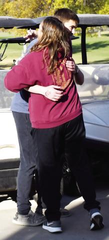 Webster Area cross country coach Cheryl McCreary embraces Webster Area runner Jase Voss after he placed 16th overall and qualified for state during the Region 1A meet award ceremony at the Webster Golf Club Oct. 16. Reporter &amp; Farmer | Brenner Cariveau