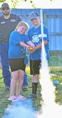 4-H siblings Holly and Hayes Zubke, eight and 11 years old respectively, work together to launch a rocket during the kickoff night at the Day County Fair Aug. 6. In the background is Connpr Fischer, who helped the youth wire up their rockets before they could be shot into the sky. The Zubke siblings are the children of Brandon and Jessica Zubke, Webster. Reporter &amp; Farmer | Amanda Dulitz