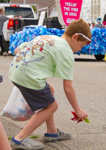 Barrett Cimburek of Mitchell picks up candy during the parade at Waubay Fun Fest July 19. The annual celebration draws hundreds of people every year to its festivities. Reporter & Farmer | Leyton Beardslee