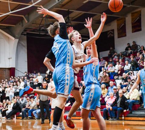 Seth Lesnar of Webster Area tosses up a shot between two Leola/Frederick defenders during the Bearcats 75-64 victory over the Titans Feb. 14 at Webster Armory. Lesnar finished the game with eight points, five rebounds and two assists. Reporter &amp; Farmer | Leyton Beardslee