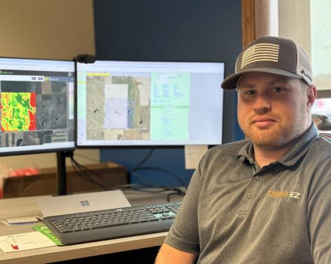 Cody Kafka sits at his work desk in Mitchell with his new land purchase displayed on his computer screen Sept. 4. Reporter &amp; Farmer | Joshua Haiar for South Dakota Searchlight