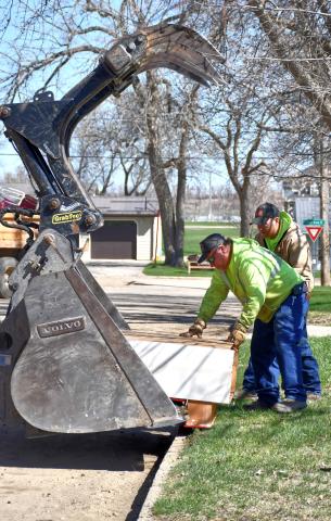 Webster clean up crew workers Danny Kirchmeier and Randy Wolff place trash into the waiting claws of a front-end loader April 29 during the citywide cleanup. This was the first year in a few that the city hosted the event. Reporter &amp; Farmer | Leyton Beardslee