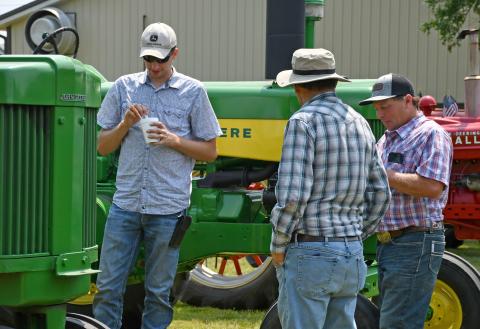 Reminiscing about the days when the antique tractors they were looking at ruled the fields and farm yards during Waubay Fun Fest’s antique tractor show are Ben Vander Schaaf, Alton, IA, David Anderson, Groton and James Jorgenson, Waubay. Reporter &amp; Farmer | Amanda Dulitz